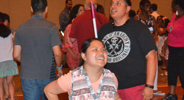 NFB members dance together at convention.